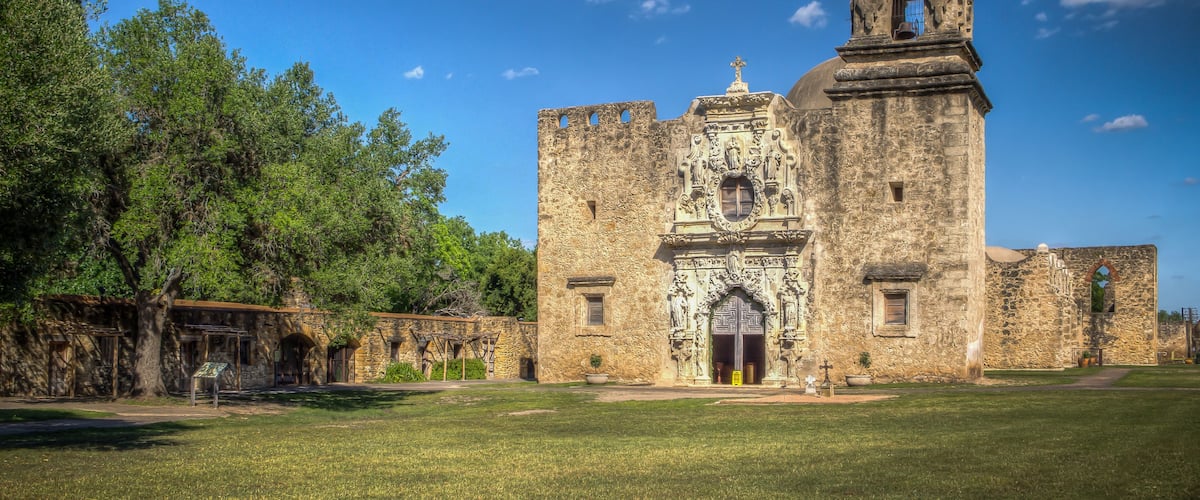 A historic stone church with a bell tower and arched entrance.