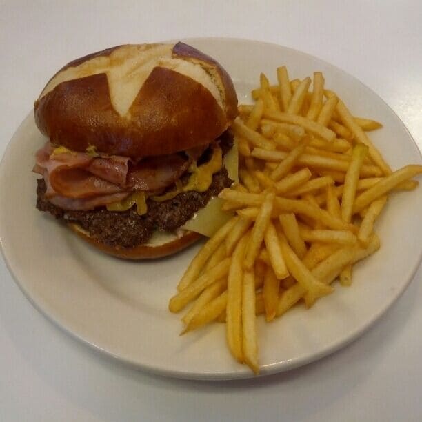The Oktoberfest Steakburger with swiss cheese, onions sauteed in mustard and thinly sliced Black Forest Ham on a pretzel bun.