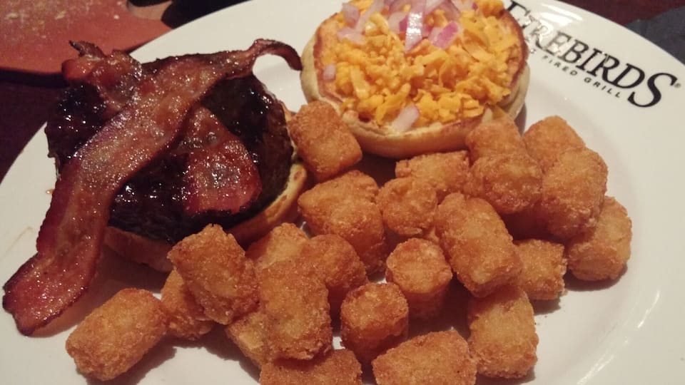 The Smokehouse Burger from Firebirds Wood Fired Grill in the Polaris area topped with java BBQ sauce, apple-wood smoked bacon, cheddar and red onion with a side of tots.
#delicious