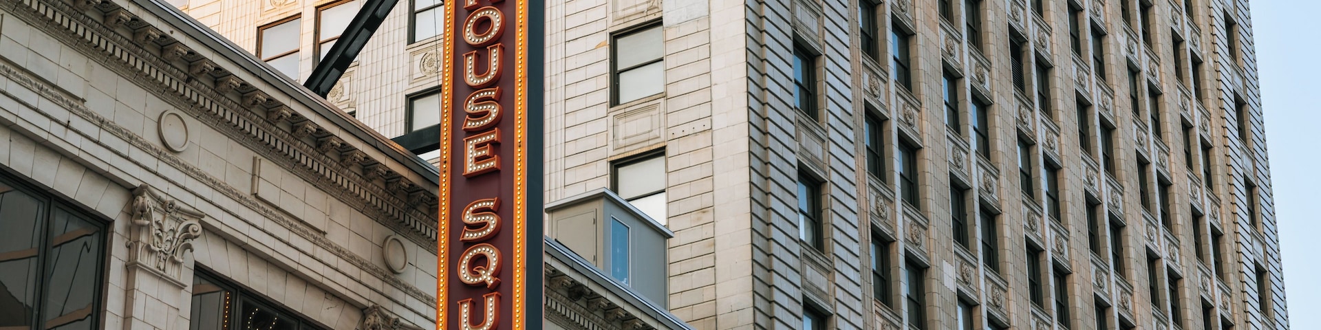 Un cartel de teatro con 'PLAYHOUSE SQUARE' escrito en letras iluminadas.