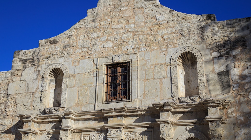 A historic stone building with arched windows and intricate carvings.
