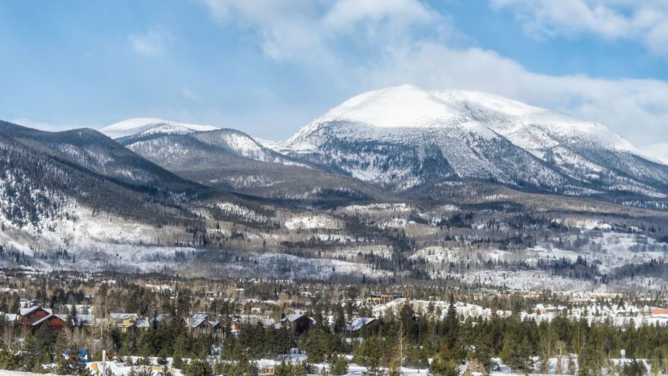 Frisco, Colorado snow capped rocky mountain Buffalo peak and houses buildings in winter weather blue sky and view of Silverthorne
