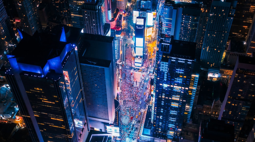 New York Concrete Jungle at Night. Aerial Shot from a Helicopter Tour Around Manhattan. Scenes with Modern Skyscraper Blocking the View on Crowded Times Square Area with Tourists