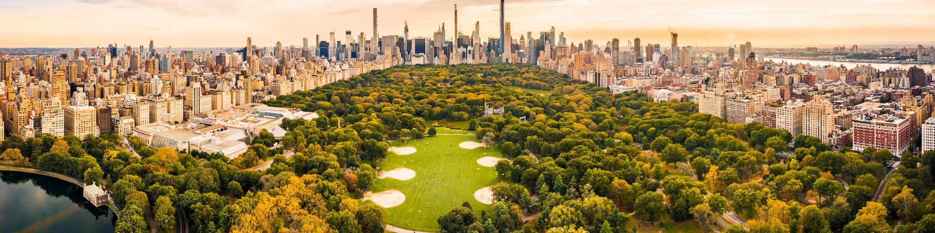 Aerial panorama of New York midtown skyline at sunset viewed from above Central Park.