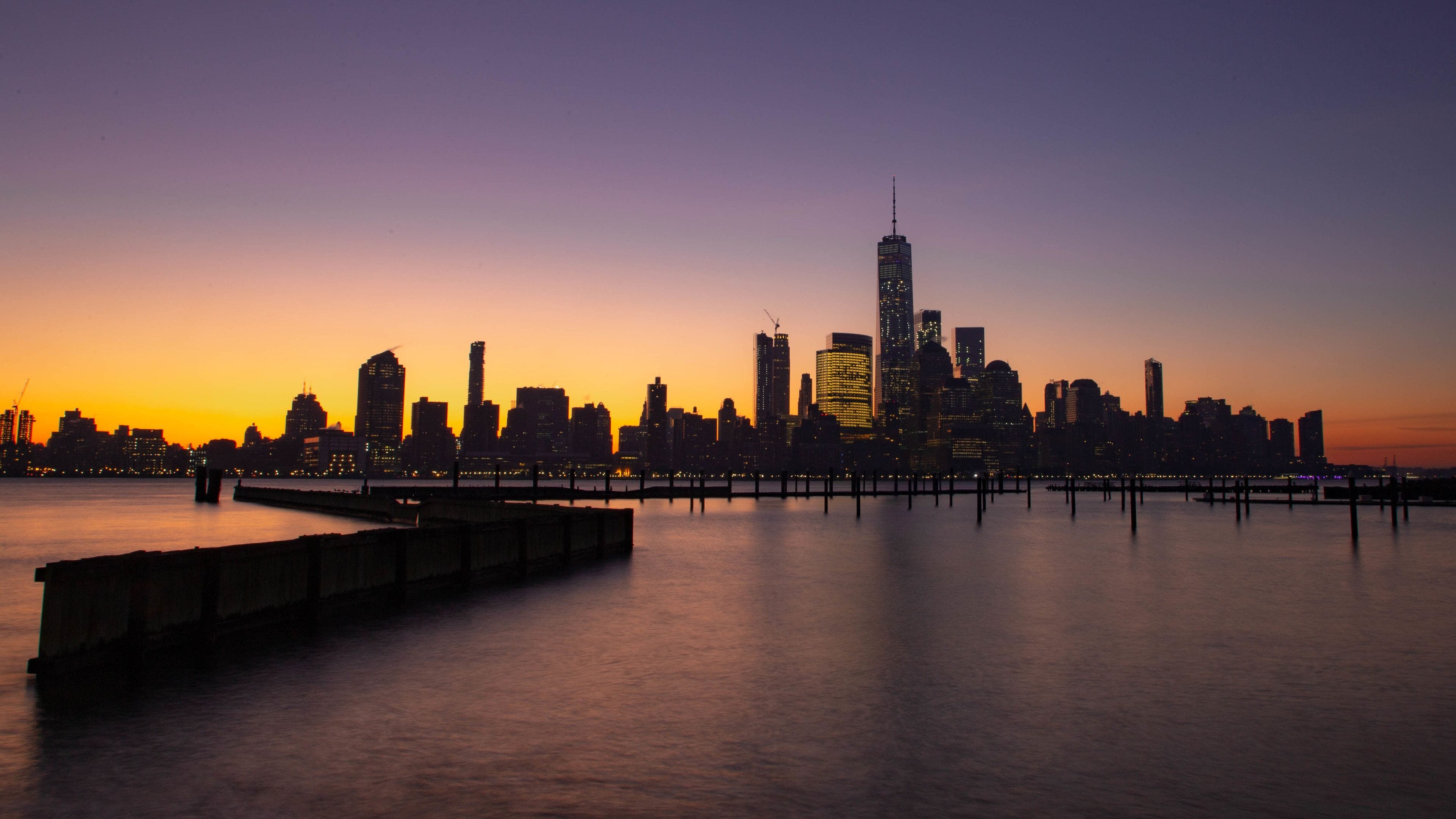 Newport showing a sunset, a bay or harbor and a city