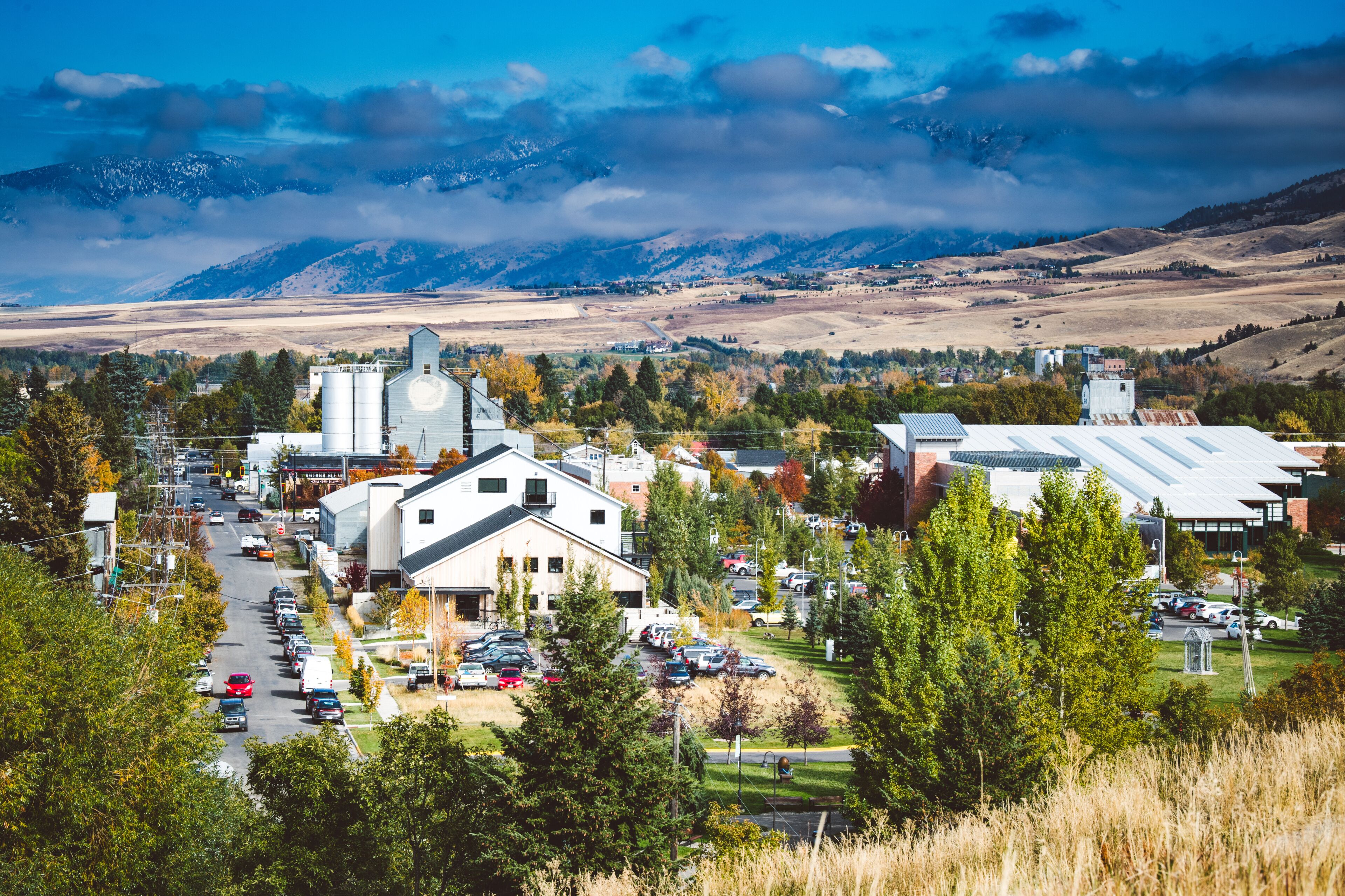 Downtown Bozeman, Montana seen from afar with mountains in the background