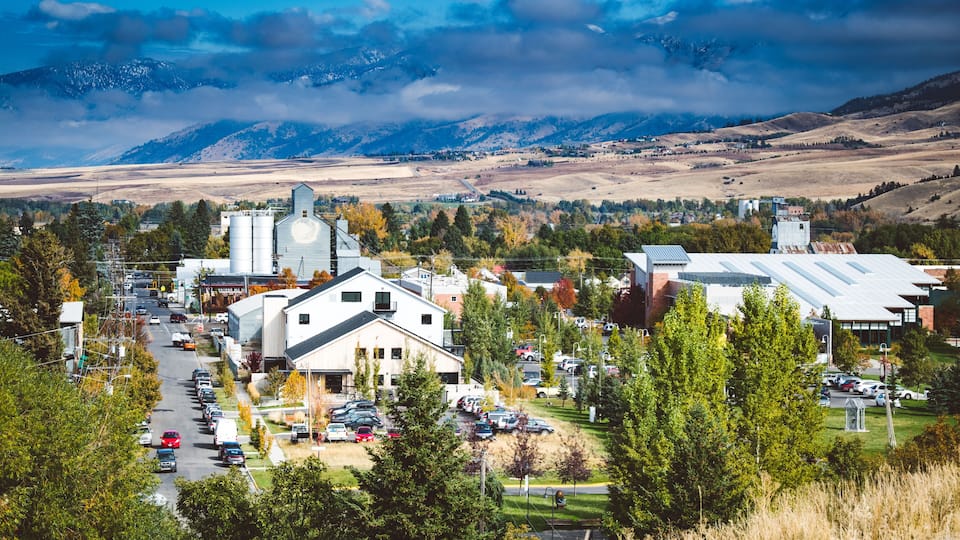 Downtown Bozeman, Montana seen from afar with mountains in the background