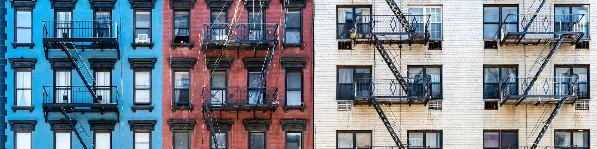 Red white and blue colored brick buildings on Second Avenue in the Upper East Side neighborhood of New York City NYC