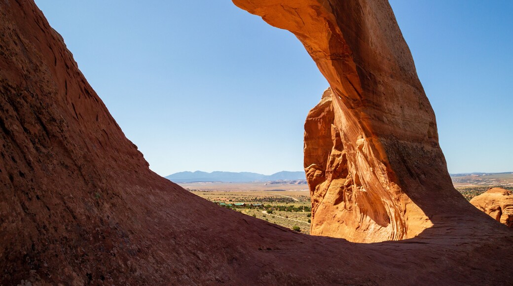 Wilson Arch, a natural sandstone arch located 24 miles south of Moab, Utah. Amazing view looking down into the valley