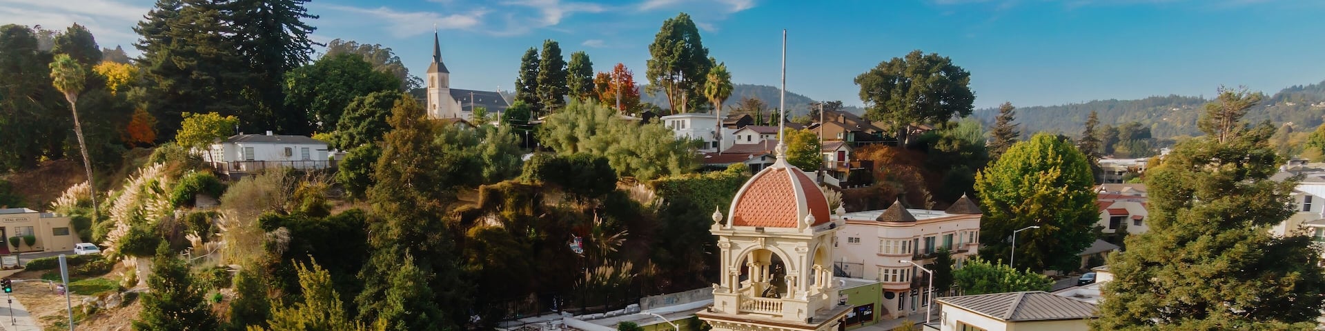 Clock tower in downtown Santa Cruz, California, USA. The tower is a local landmark and gathering place, decorated with flowers and pumpkins.