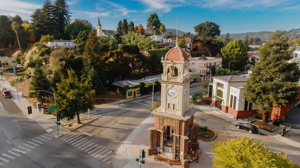 Clock tower in downtown Santa Cruz, California, USA. The tower is a local landmark and gathering place, decorated with flowers and pumpkins.