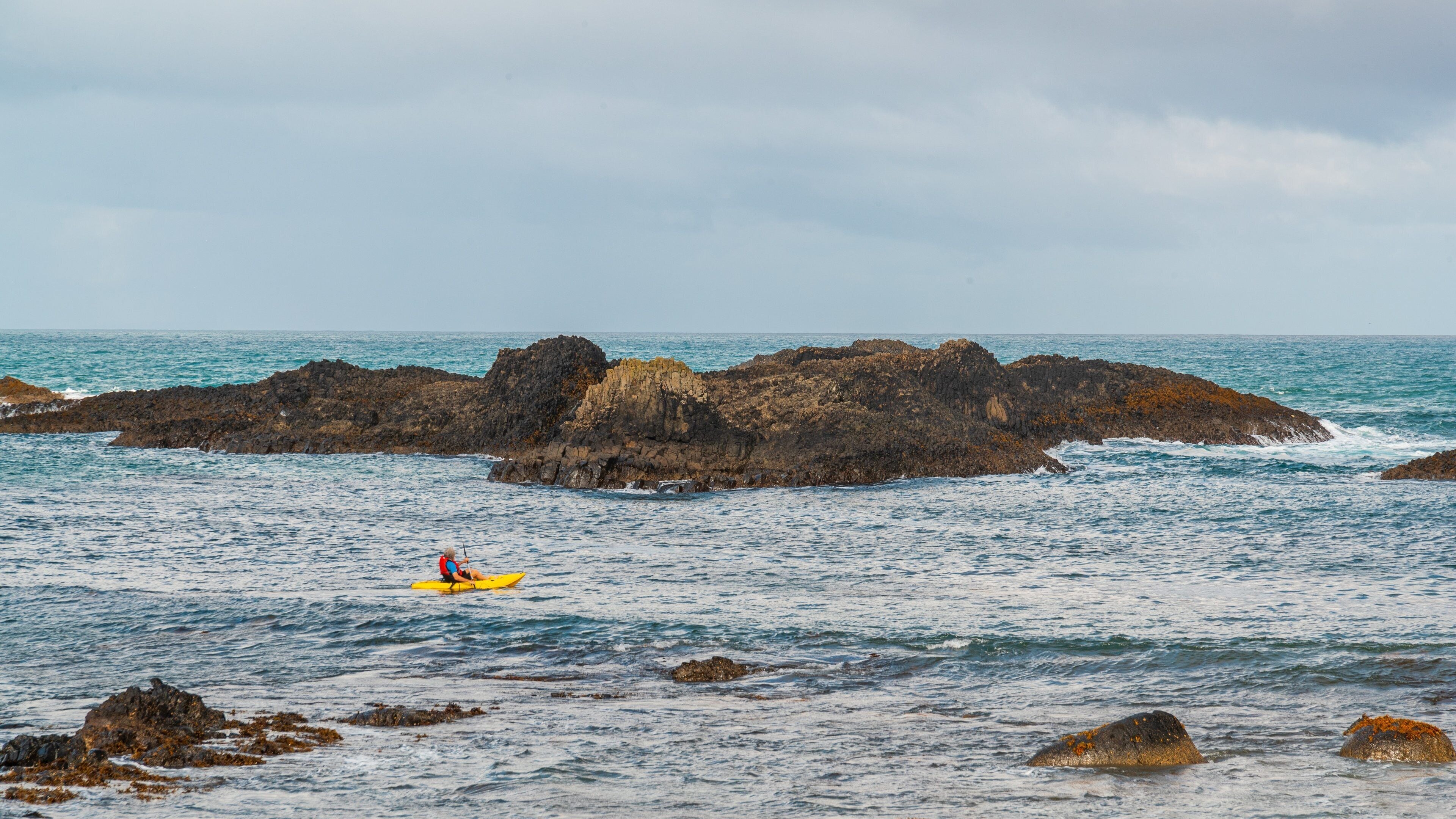 Ballintoy Harbour showing general coastal views, boating and rocky coastline