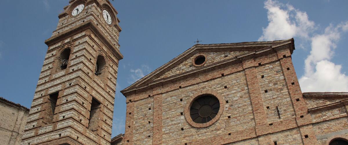 A historic church with a bell tower and a large wooden door.