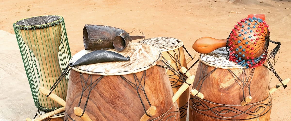 A set of traditional wooden drums with intricate carvings and colorful decorations.