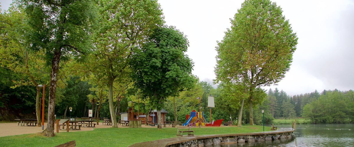 Lac de Lourdes which includes a lake or waterhole and a park