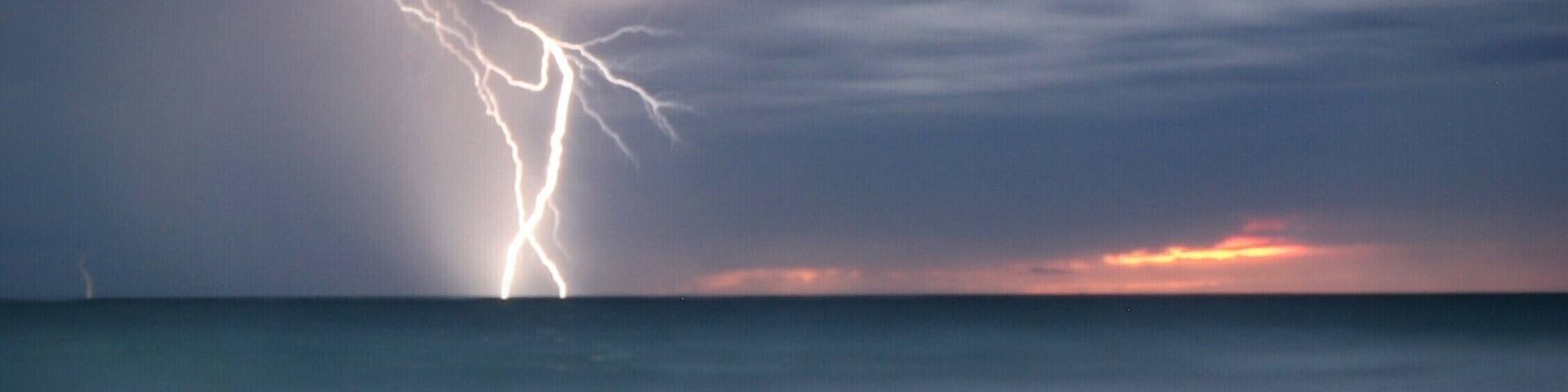 Headed down to Shorehaven Beach at golden hour.... Storm clouds brewing... Tried long exposure and captured lightning on the horizon...