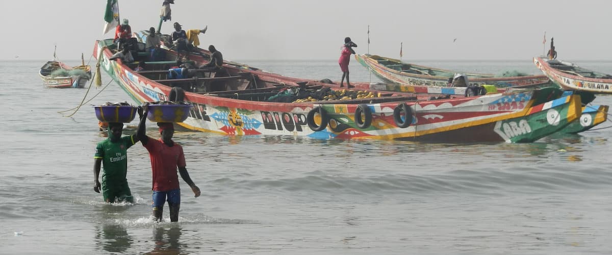 A group of colorful boats docked at a pier.