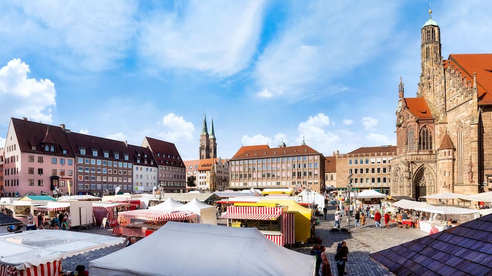 Nuremberg, Marketplace with cathedral and market stalls on a sunny day in Autumn