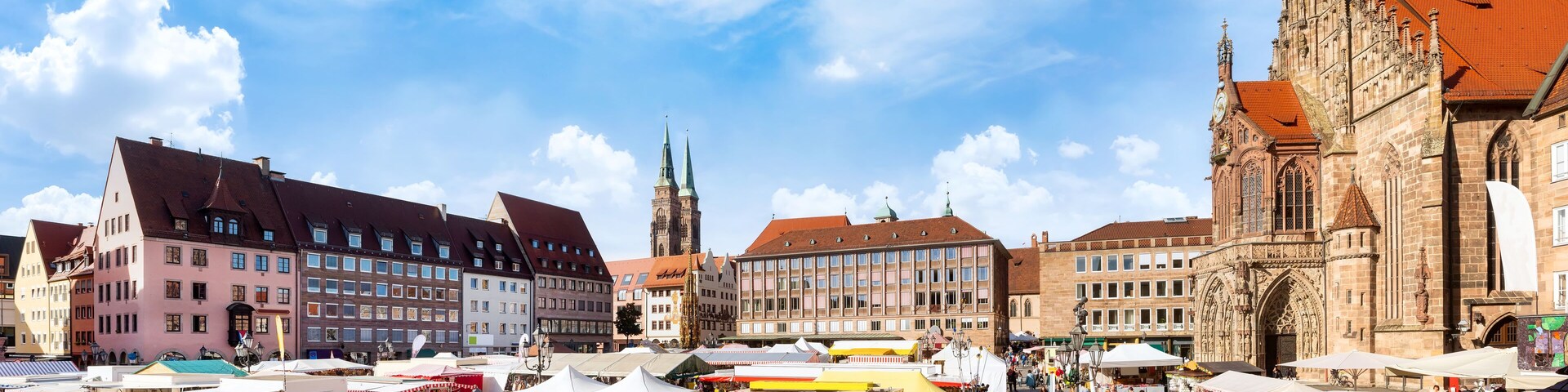 Nuremberg, Marketplace with cathedral and market stalls on a sunny day in Autumn