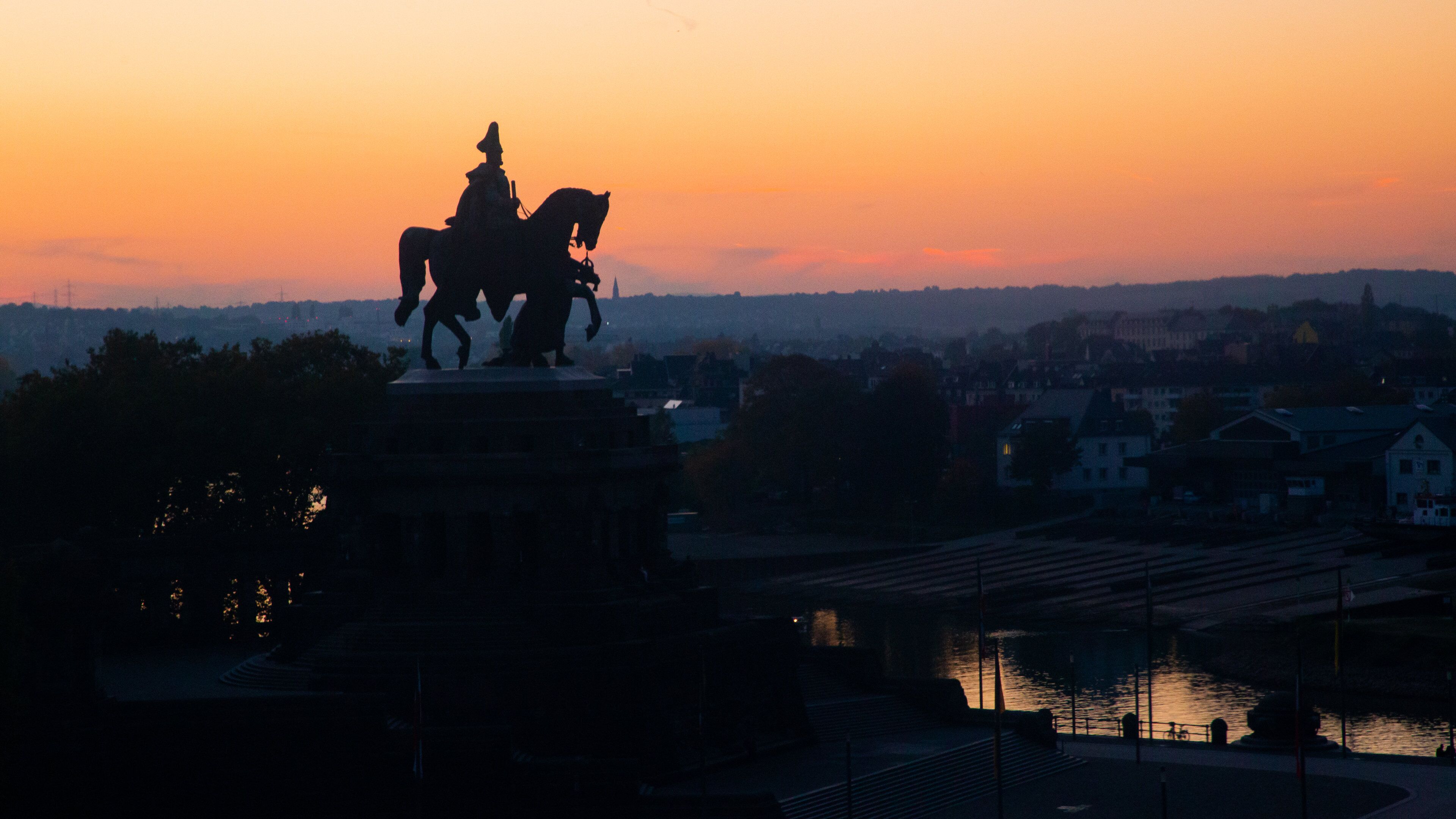Altstadt Koblenz featuring a statue or sculpture and a sunset