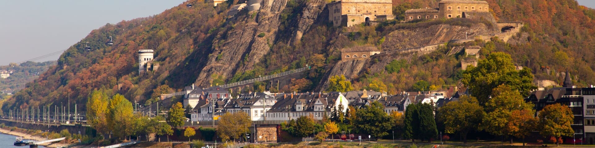A castle on a hill overlooking a river.