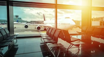 Airport gate waiting area and jumbo jet sunset view