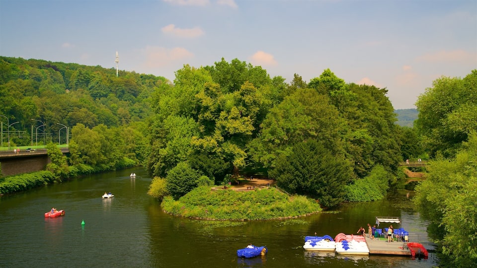 A river with boats, a dock, and lush greenery.