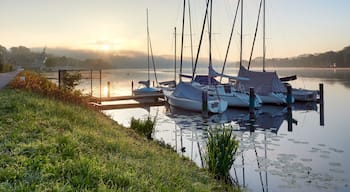 A wonderful sunrise over Lake Baldeneysee in the city of Essen. Moored sailboats in the foreground. Landscape photography
