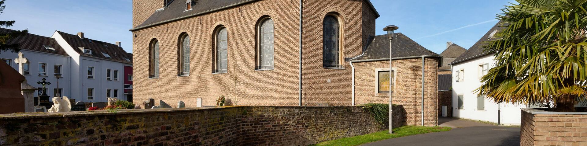 A church with a tall steeple and a brick facade.