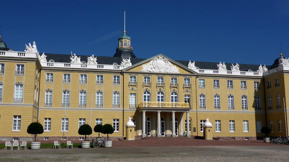 A large yellow building with ornate decorations and a prominent entrance.