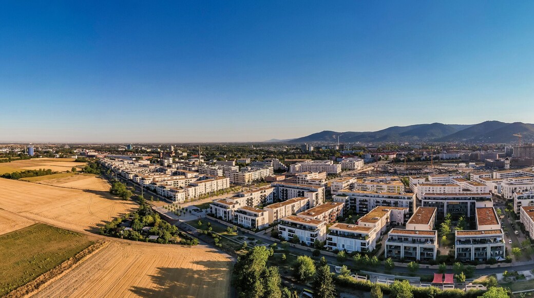Germany, Baden-Wurttemberg, Heidelberg, Aerial panorama of sun shining over passive house settlement Bahnstadt
