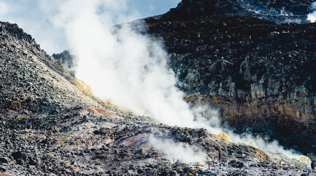Powerful fumarole releasing white steam from Mount Io volcano