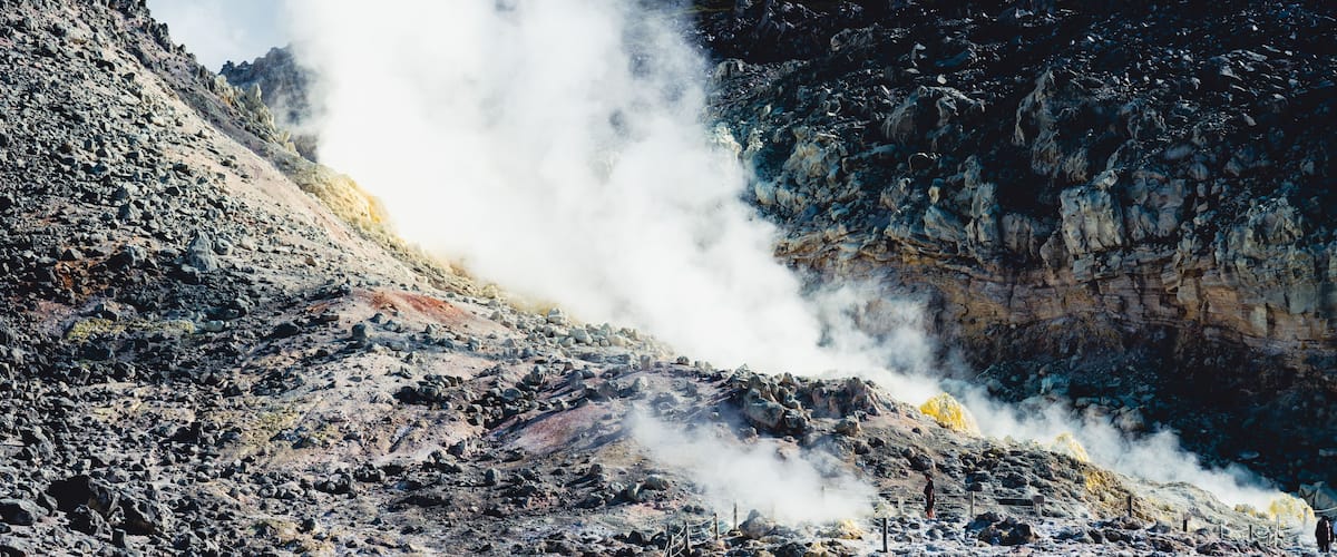 Powerful fumarole releasing white steam from Mount Io volcano