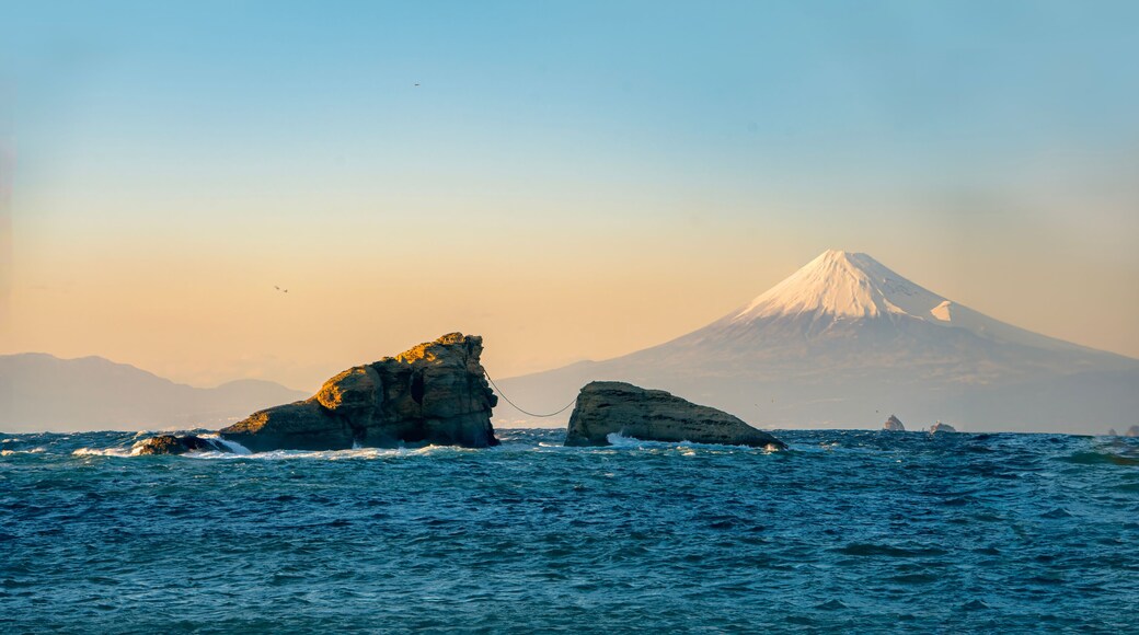 Mount Fuji Sunset View with Sacred Wedded Rocks at Kumoni Shore, Izu Peninsula, Japan. A breathtaking sunset view from Kumoni Shore on the Izu Peninsula, Japan.