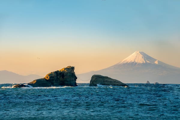 Mount Fuji Sunset View with Sacred Wedded Rocks at Kumoni Shore, Izu Peninsula, Japan. A breathtaking sunset view from Kumoni Shore on the Izu Peninsula, Japan.