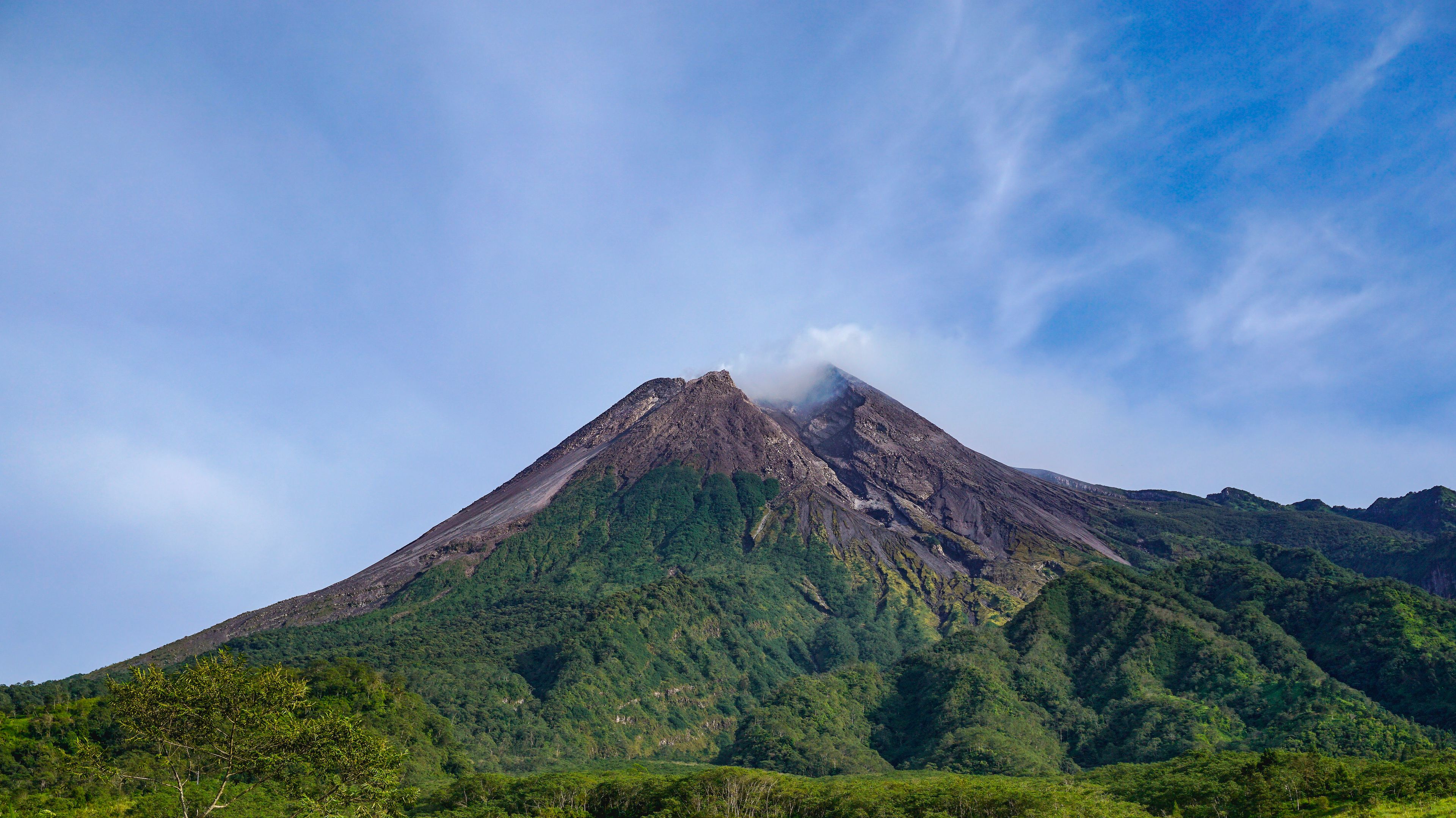 Majestic Mount Merapi Volcano Landscape with Blue Sky and Green Forest in Yogyakarta