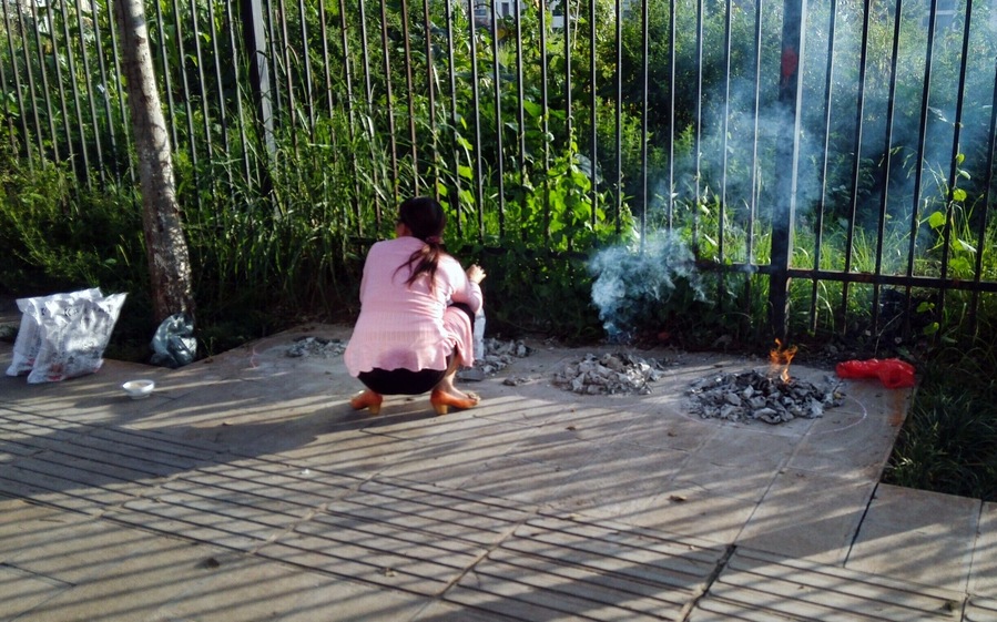 It is the little things in life that matter
Yesterday, I noticed many people burning paper piles along the street.  I know that this kind of paper is called Joss Paper(maybe jinzhi - 金纸) and that it is usually burnt for offering to the dead.
I will ask my students and try to get a better answer later, but in any event, it is a tradition that is displayed without much pomp and circumstances and speaks to Chinese culture.  Do your thing and move on...very cool.