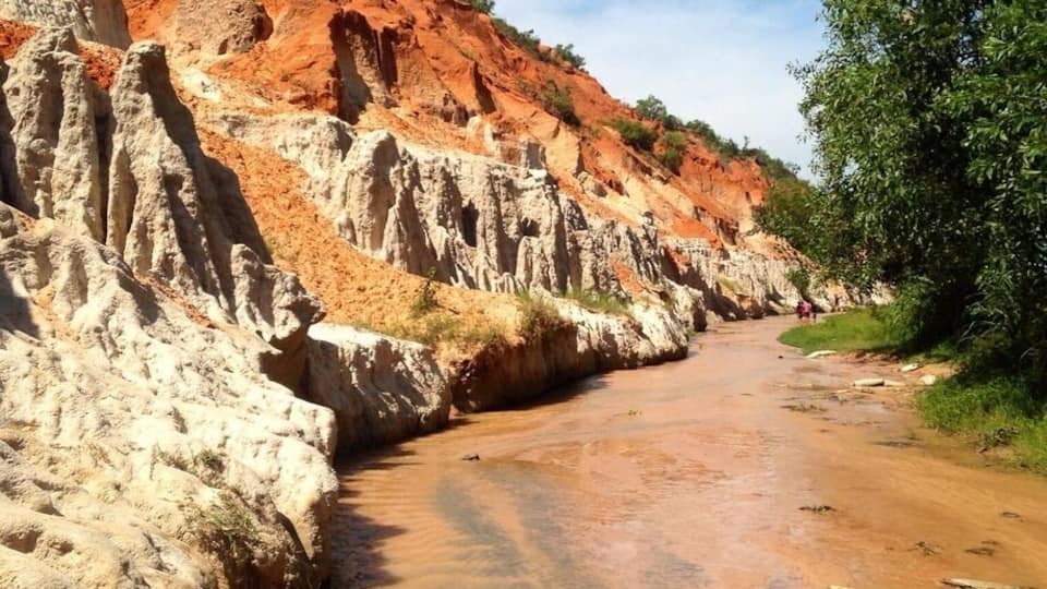 This was our 40 minute trek at FairyStream through this river to a small waterfall at the top of the stream. This area is really close to Mui Ne and there are some nice sand formations. The water looks clean in the picture, but it was polluted throughout our walk upstream. As you arrive at the river there are guys trying to charge you a fee to leave your shoes/sandals. You don't have to pay and you can take them with you. We used our Keen Sandals which were helpful as further upstream there are more rocks in the water. This was part of an afternoon trip with Muine Backpackers travel and tour agent. We all went in a Russian Jeep to the Fairy Stream, views overlooking some fishing boats (unfortunately a very polluted beach), then onto the white sand dunes and a sunset at the red sand dunes. All of this for $7 per person. We wanted to rent a scooter but after seeing the roads on the way to the white sand dunes we were happy we didn't. Terrain for a jeep or off-road bike. The only downfall was they overbooked the tour and it was a tight squeeze in the back of the Jeep. Overall it was a good #roadtrip which combined everything you need to see in Mui Ne or surrounding area.