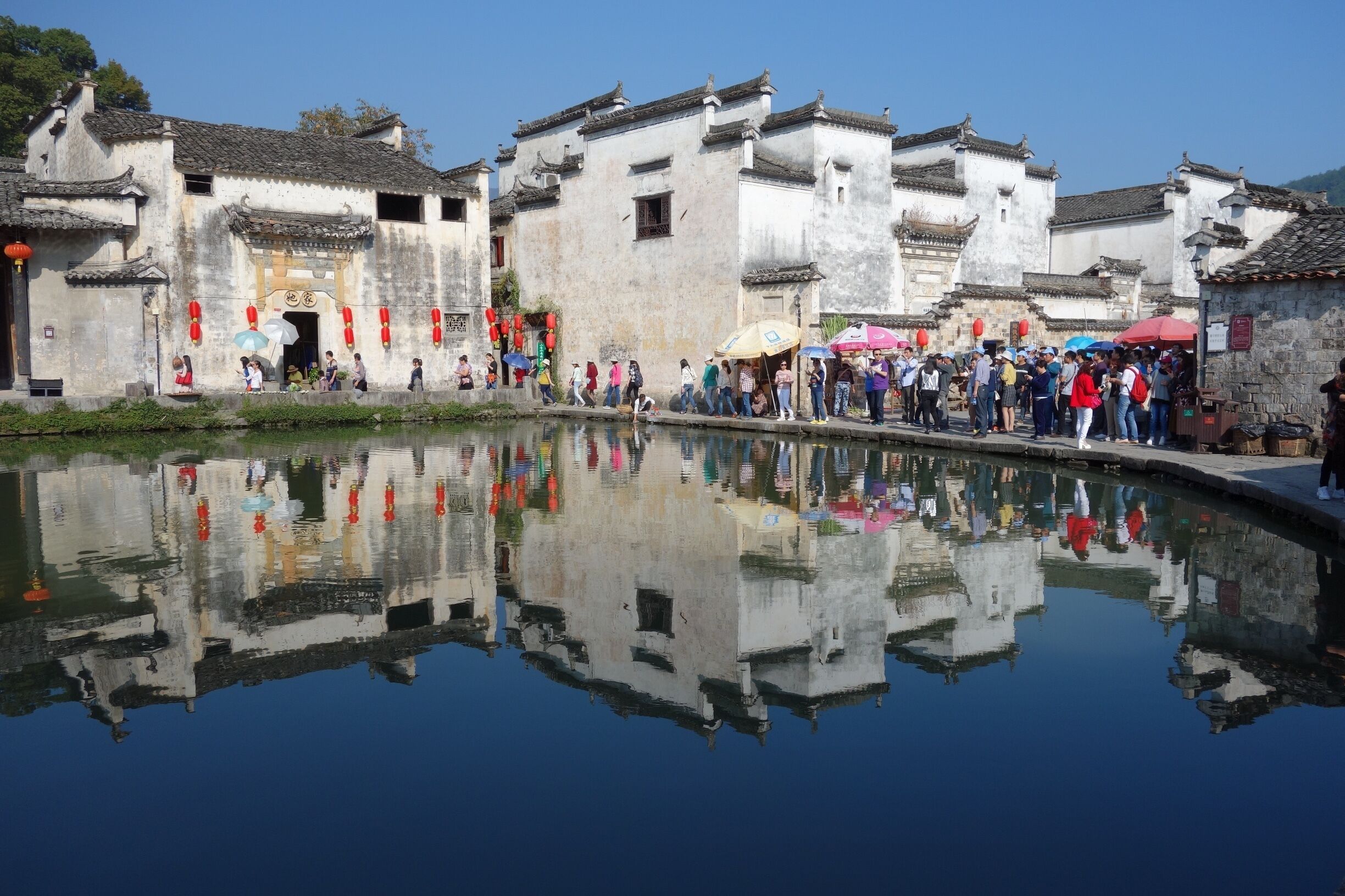 Traditional Chinese architecture with a clear reflection in the water.