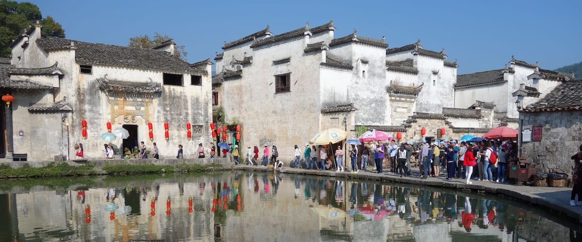 Traditional Chinese architecture with a clear reflection in the water.