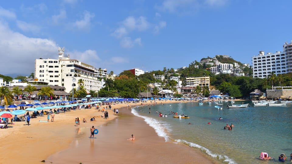 A view of Caleta beach, it can see Sand and people