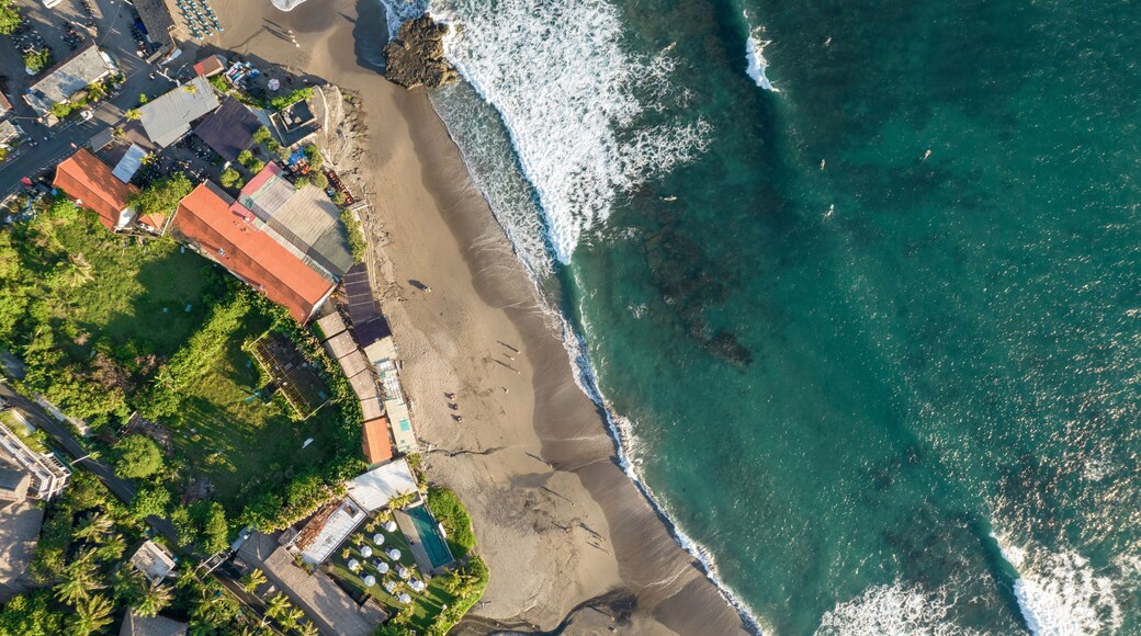 Drone aerial view of beach and buildings on the shoreline at Batu Bolong; Canggu, Bali, Indonesia