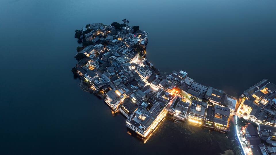 Village and lake in Shuanglang, Yunnan, China.
