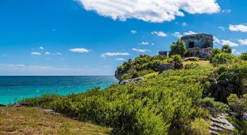 A panorama view out to sea beside the temple of the wind god at the Mayan settlement of Tulum, Mexico on a sunny day