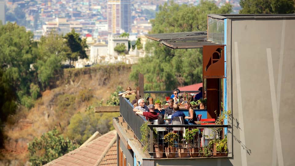 A balcony overlooking a cityscape with buildings and trees.