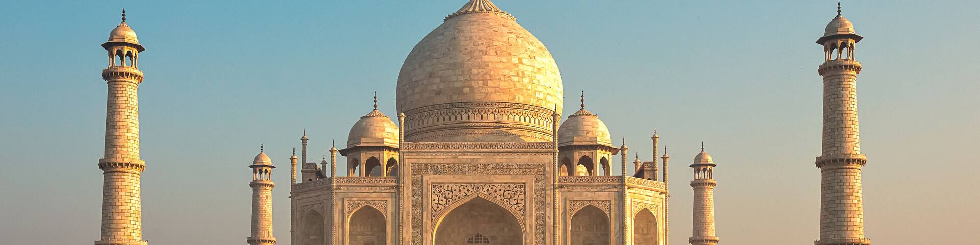 The Taj Mahal with four minarets and a large central dome.