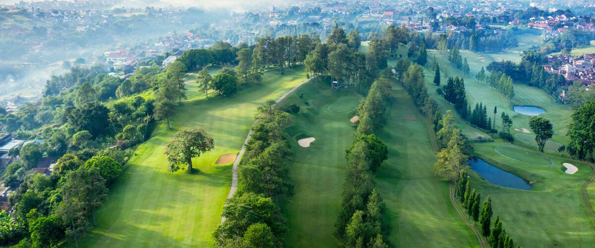 Beautiful golf course with misty Bandung cityscape