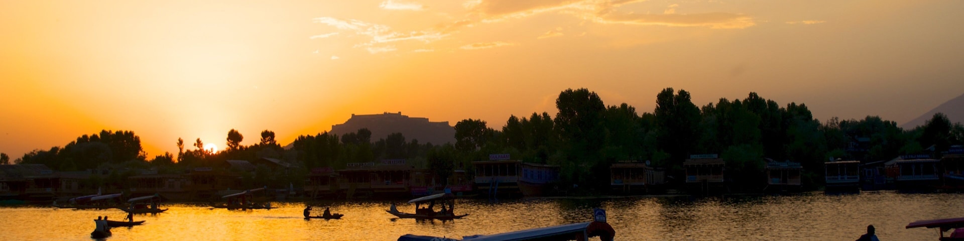 Srinagar showing a lake or waterhole, a sunset and boating