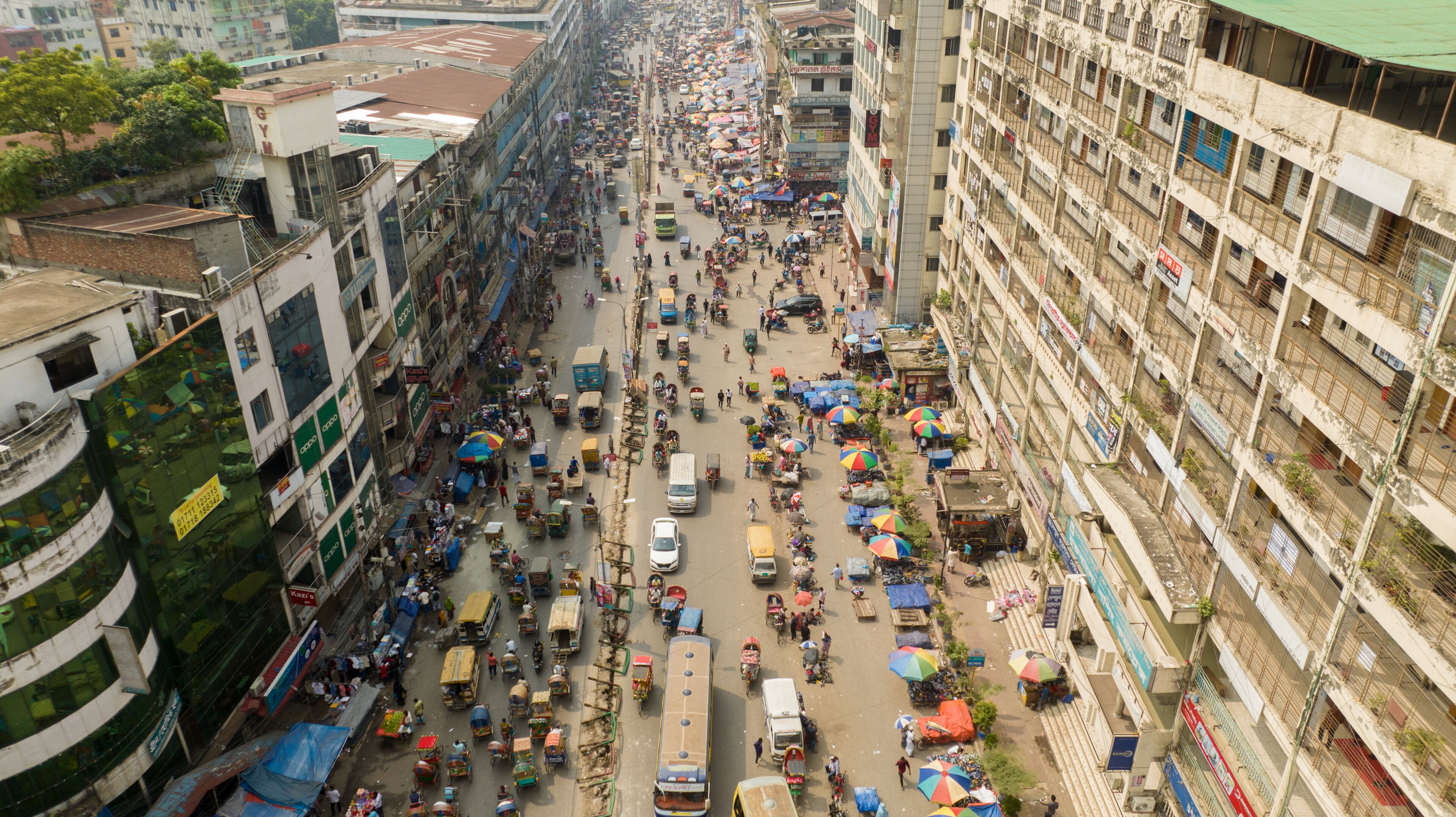 Aerial view of a bustling street scene, where vehicles and people navigate the crowded Mirpur 1, Dhaka, Bangladesh.