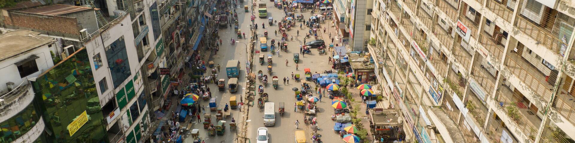 Aerial view of a bustling street scene, where vehicles and people navigate the crowded Mirpur 1, Dhaka, Bangladesh.